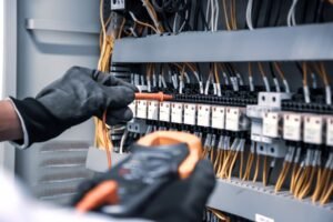 An electrical engineer tests the current and voltage of electrical cables.